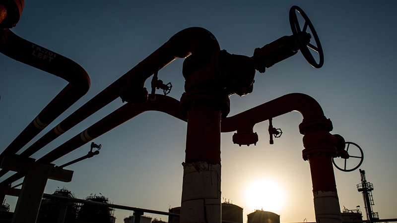 Photo of oil pipes and valves near a petrochemical plant