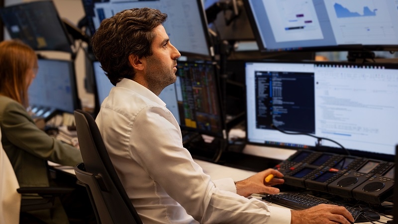 Financial worker looking at computer screen.