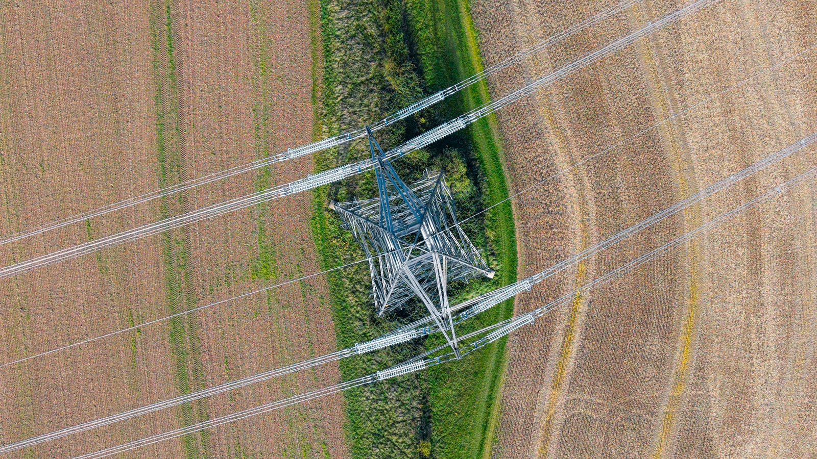 Overhead photo of electrical pylons in a field