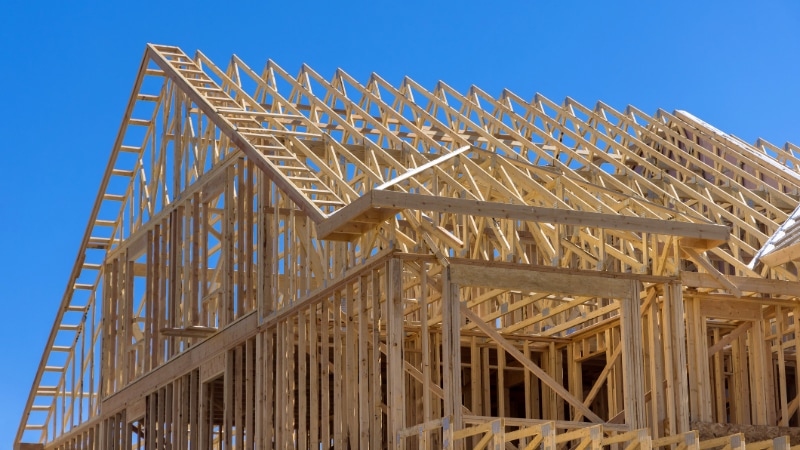 Photo showing wooden beams for a house under construction.