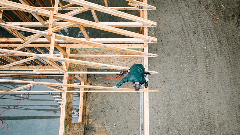 A worker builds the frame of a new house in Washington state