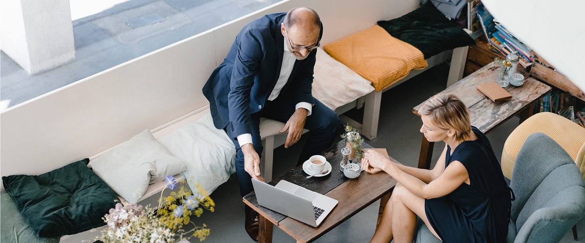 Two people mid-conversation at a cafe table