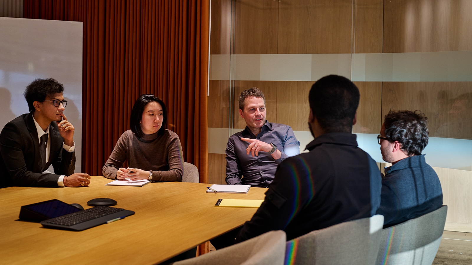 Thomas with colleagues in a conference room